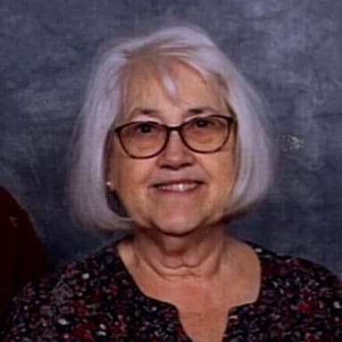 Sheila Fleischauer in front of a gray background